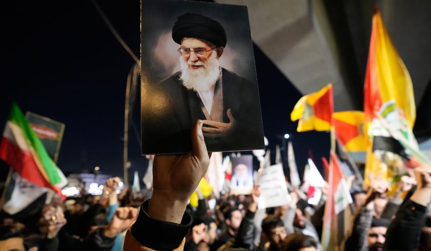 A protester holds a portrait of Iran's Supreme Leader Ayatollah Ali Khamenei during a protest against U.S. and Israeli attacks on multiple cities across Iran at a bridge leading to the fortified Green Zone where the U.S. embassy is located in Baghdad, Iraq, Saturday, Feb. 28, 2026. (AP Photo/Hadi Mizban) **FILE**