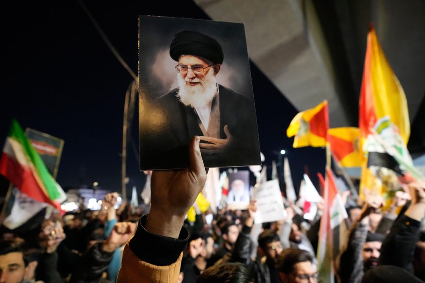 A protester holds a portrait of Iran's Supreme Leader Ayatollah Ali Khamenei during a protest against U.S. and Israeli attacks on multiple cities across Iran at a bridge leading to the fortified Green Zone where the U.S. embassy is located in Baghdad, Iraq, Saturday, Feb. 28, 2026. (AP Photo/Hadi Mizban) **FILE**