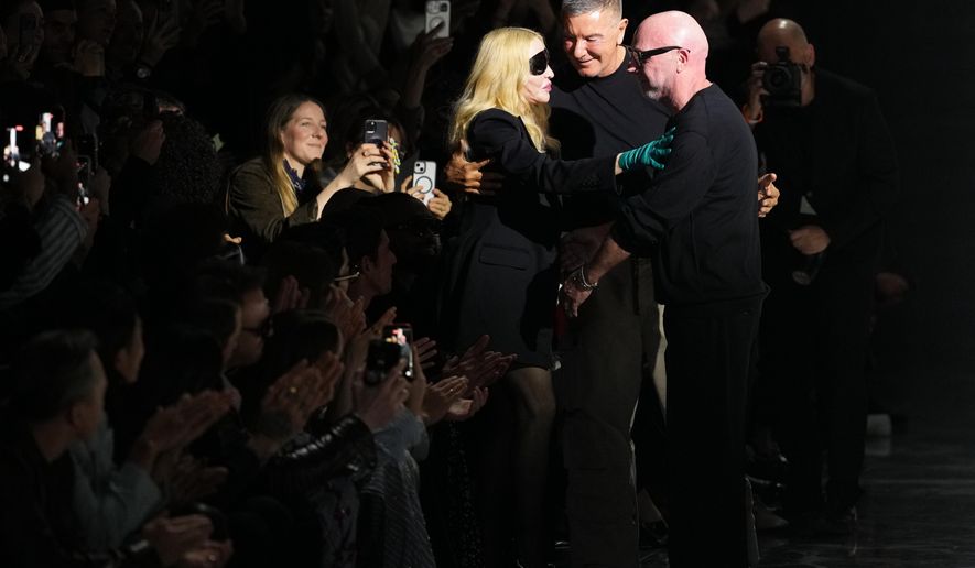 Madonna congratulates Domenico Dolce, right, and Stefano Gabbana at the end of the Dolce & Gabbana Fall/Winter 2026-2027 Women's collection, presented in Milan, Italy, Saturday, Feb. 28, 2026. (AP Photo/Antonio Calanni)