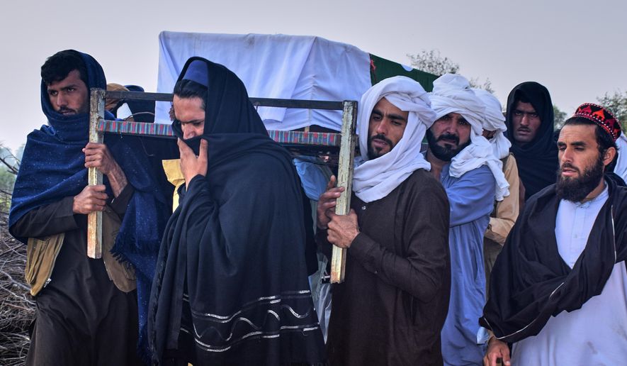 People carry the coffin of an army soldier, killed in the cross-border clashes of Pakistan and Afghan forces, for his funeral prayer at a village in Lakki Marwat, a district of Pakistan's Khyber Pakhtunkhwa province, Saturday, Feb. 28, 2026. (AP Photo/G.A. Marwat)
