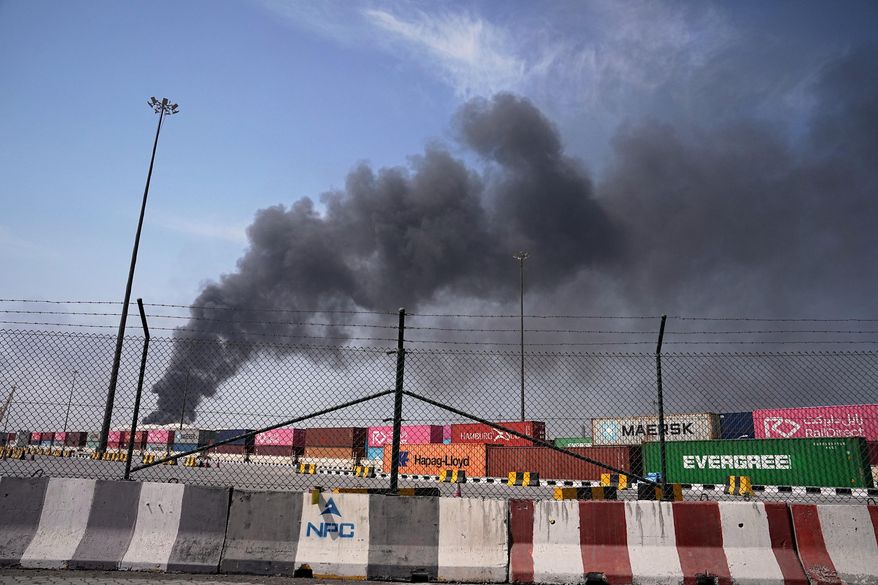 Smoke rises after an Iranian drone attack in the port area of Dubai, United Arab Emirates, Sunday, March 1, 2026. (AP Photo/Fatima Shbair)