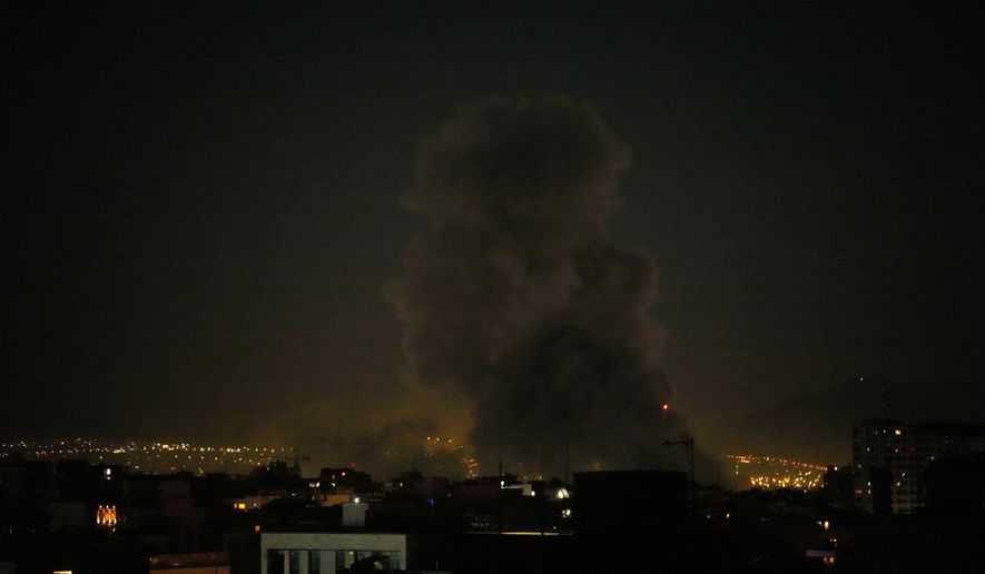 A plume of smoke rises after a strike in Tehran, Iran, Sunday, March 1, 2026. (AP Photo/Vahid Salemi)