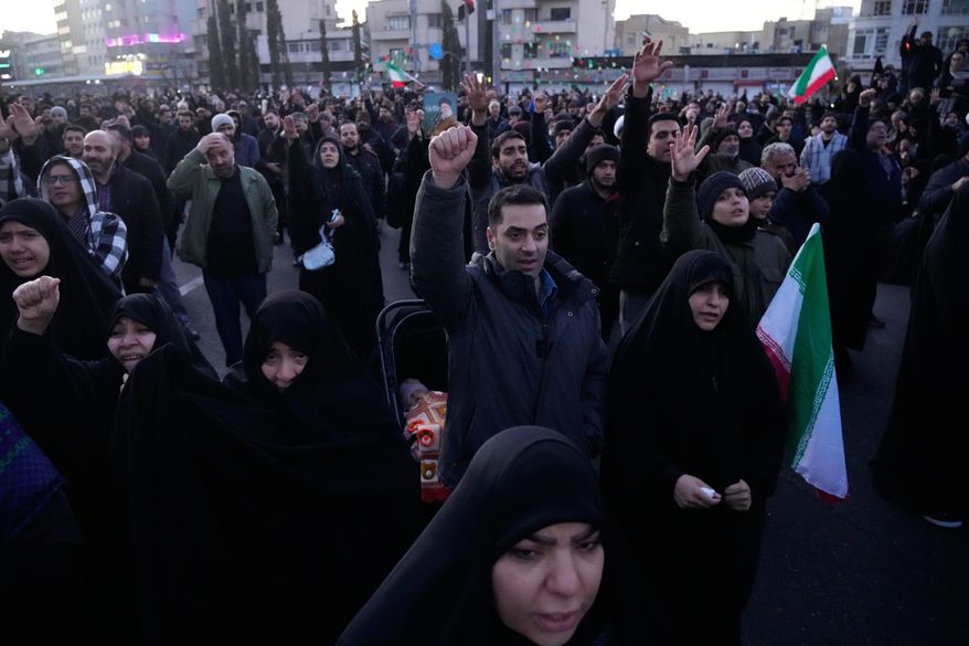 Government supporters chant slogans as they gather in mourning after state TV officially announced the death of Iranian Supreme Leader Ayatollah Ali Khamenei, in Tehran, Iran, Sunday, March 1, 2026. (AP Photo/Vahid Salemi)
