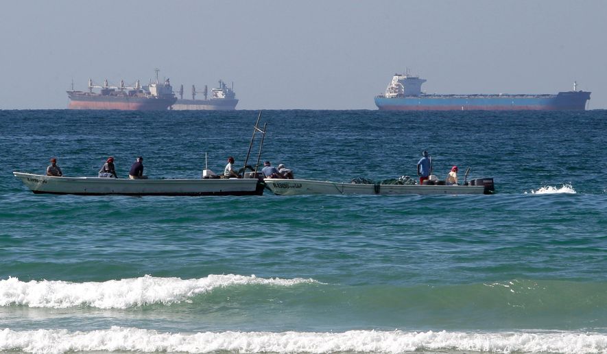 Fishermen work in front of oil tankers south of the Strait of Hormuz, Jan. 19, 2012, offshore the town of Ras Al Khaimah in the United Arab Emirates. (AP Photo/Kamran Jebreili) **FILE**