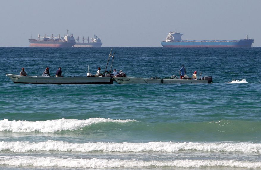 Fishermen work in front of oil tankers south of the Strait of Hormuz, Jan. 19, 2012, offshore the town of Ras Al Khaimah in the United Arab Emirates. (AP Photo/Kamran Jebreili) **FILE**