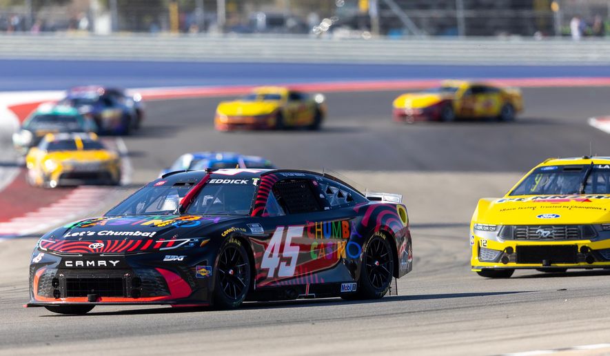 23XI Racing's Tyler Reddick (45) and Team Penske's Ryan Blaney drive through Turn 13 during a NASCAR Cup Series auto race in Austin, Texas, Sunday, March 1, 2026. (AP Photo/Stephen Spillman)