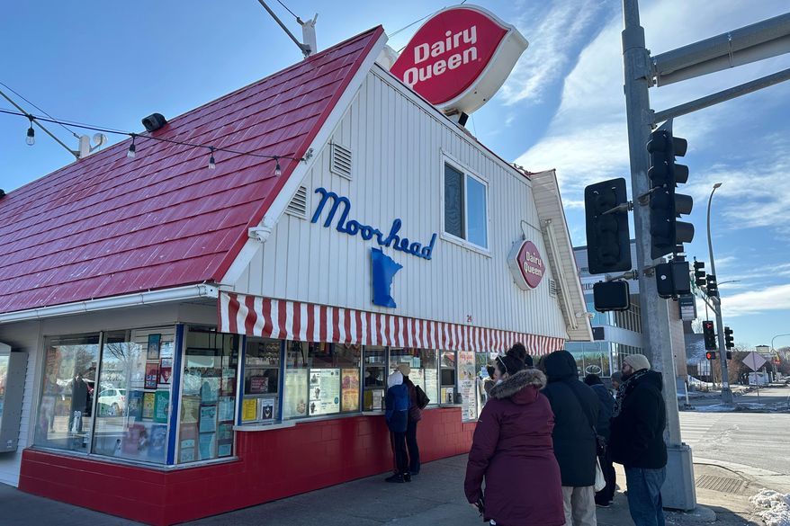 Customers wait their turn to place their order Sunday, March 1, 2026, during the annual opening day of the Dairy Queen in Moorhead, Minn. (AP Photo/Jack Dura)