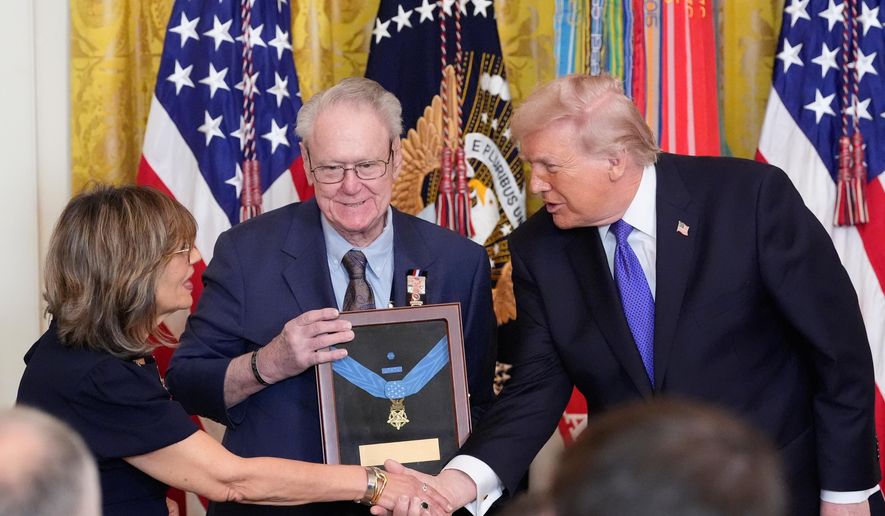 President Donald Trump posthumously presents the Medal of Honor to Robert and Linda Ollis, parents of Staff Sgt. Michael Ollis, during a ceremony in the East Room of the White House, Monday, March 2, 2026, in Washington. (AP Photo/Alex Brandon)