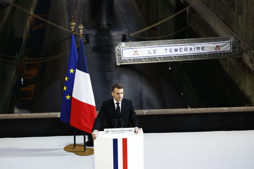 French President Emmanuel Macron delivers a speech next to the submarine 'Le Temeraire' (The Temerarious) at the Nuclear submarines Navy base of Ile Longue in Crozon, France, Monday March 2, 2026. (Yoan Valat/Pool Photo via AP)