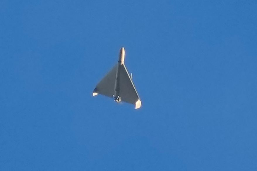 An Iranian Shahed exploding drone launched by Russia flies through the sky seconds before it struck buildings in Kyiv, Ukraine, on Oct. 17, 2022. (AP Photo/Efrem Lukatsky, File)