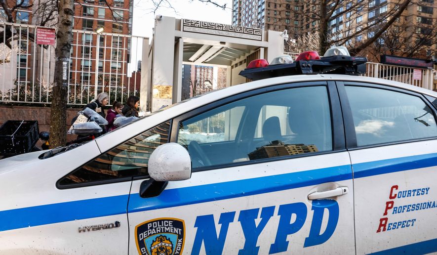 NYPD cars are seen outside the Slamic Cultural Center of New York, Saturday, Feb. 28, 2026, in New York. (AP Photo/Kena Betancur)