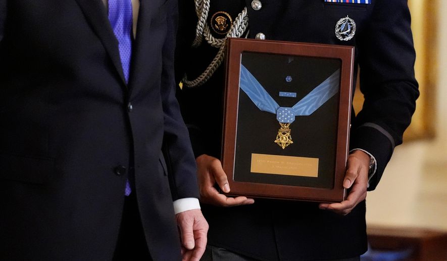 Military aide holds the Medal of Honor for Master Sgt. Roderick Edmonds, to be presented posthumously to his son Chris Edmonds, in a ceremony in the East Wing of the White House in Washington, Monday, March 2, 2026. (AP Photo/Mark Schiefelbein)