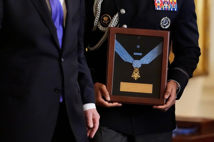 Military aide holds the Medal of Honor for Master Sgt. Roderick Edmonds, to be presented posthumously to his son Chris Edmonds, in a ceremony in the East Wing of the White House in Washington, Monday, March 2, 2026. (AP Photo/Mark Schiefelbein)