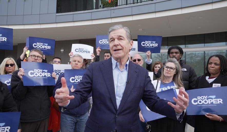 Democratic former Gov. Roy Cooper, who is running for U.S. Senate, speaks to reporters after casting his ballot on the first day of in-person early voting in the state's primary election, Thursday, Feb. 12, 2026, in Raleigh, N.C. (AP Photo/Allen G. Breed)
