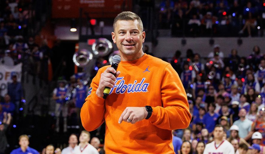 Florida football head coach Jon Sumrall addresses the crowd during the first half of an NCAA college basketball game against Auburn, Jan. 24, 2026, in Gainesville, Fla. (AP Photo/Chris Watkins, File)