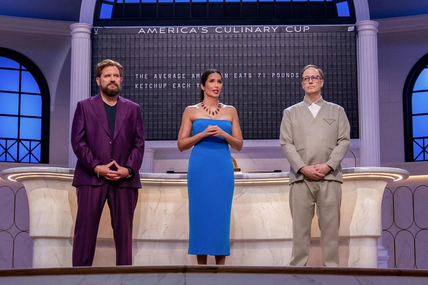 This image released by CBS shows, from left, Michael Cimarusti, Padma Lakshmi, and Wylie Dufresne on the set of the cooking competition series "America's Culinary Cup." (Jackie Brown/CBS via AP)