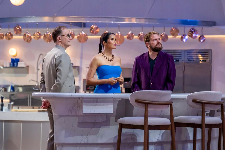This image released by CBS shows, from left, Wylie Dufresne, Padma Lakshmi, and Michael Cimarusti on the set of the cooking competition series "America's Culinary Cup." (Jackie Brown/CBS via AP)