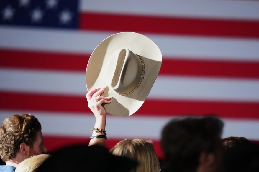 A supporter raises their hat at an election night primary watch party for Texas Attorney General Ken Paxton, a Republican candidate for the U.S. Senate, on Tuesday, March 3, 2026, in Dallas. (AP Photo/Julio Cortez)