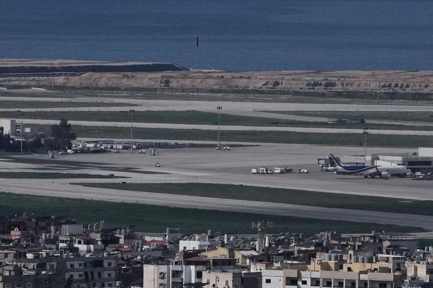 A bomb dropped from an Israeli jet falls before hitting a building in Dahiyeh, Beirut's southern suburb, near Rafik Hariri International Airport, Lebanon, Wednesday, March 4, 2026. (AP Photo/Bilal Hussein)