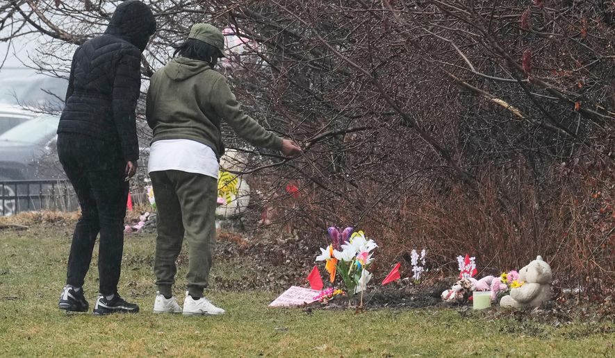 People visit a memorial at the site where two girls bodies were found earlier this week, in Cleveland, Thursday, March 5, 2026. (AP Photo/Sue Ogrocki)