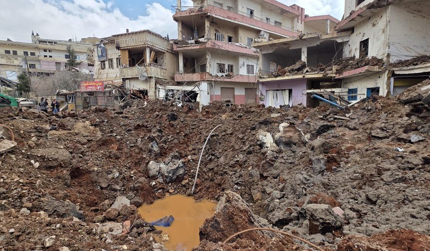 A huge crater left by an Israeli airstrike in the village of Nabi Chit, eastern Lebanon late Friday, March 6, 2026, where Israeli forces landed overnight and dug a grave in a cemetery searching for Israeli co-pilot Ron Arad who was captured and then went missing after his fighter jet crashed over south Lebanon in 1986. (AP Photo/Ali Salem)