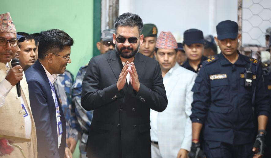 Balendra Shah, foreground, former mayor of Kathmandu Metropolitan City and prime ministerial candidate of the Rastriya Swatantra Party, arrives to receive his victory certificate after defeating former Prime Minister Khadga Prasad Oli of the Communist Party of Nepal–Unified Marxist-Leninist (CPN-UML) in Jhapa, about 267 miles (430 kilometers) southeast of Kathmandu, Nepal, Sunday, March 8, 2026. (AP Photo/Umesh Karki)