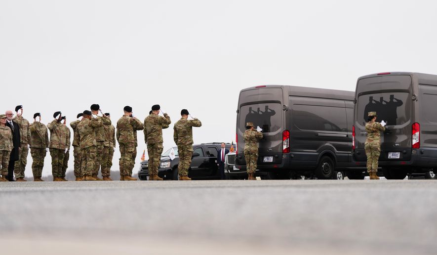 An Army carry team salute transfer vans with the remains of U.S. Army Reserve soldiers Maj. Jeffrey O'Brien, 45, of Indianola, Iowa, Capt. Cody Khork, 35, of Winter Haven, Florida, Chief Warrant Officer 3 Robert Marzan, 54, of Sacramento, Sgt. 1st Class Nicole Amor, 39, of White Bear Lake, Minnesot, Sgt. 1st Class Noah Tietjens, 42, of Bellevue, Nebraska and Sgt. Declan Coady, 20, of West Des Moines, Iowa, who was killed in a drone strike at a command center in Kuwait after the U.S. and Israel launched its military campaign against Iran, during a casualty return, Saturday, March 7, 2026, at Dover Air Force Base, Del. (AP Photo/Julia Demaree Nikhinson)