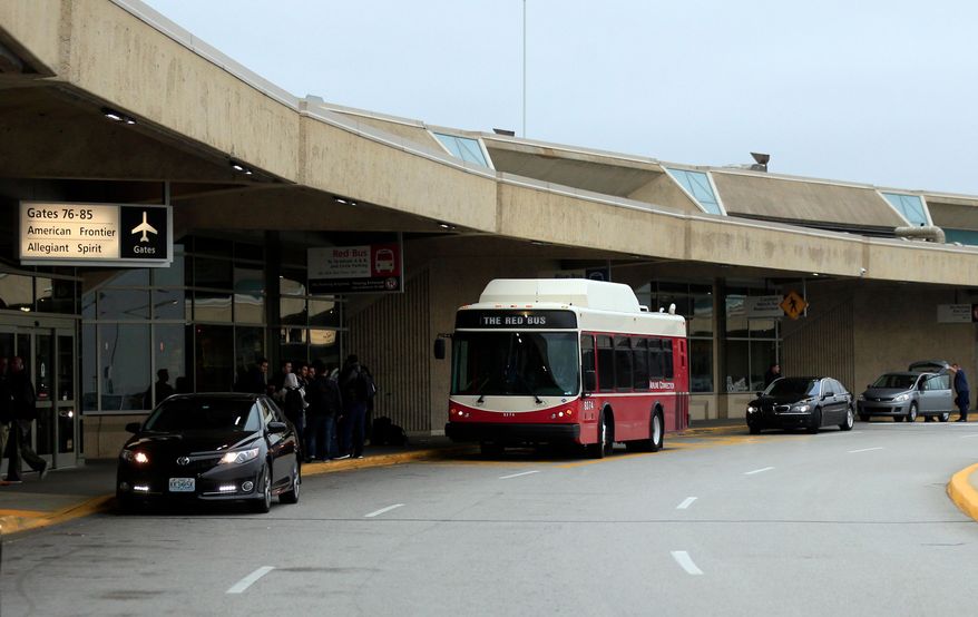 FILE - A bus picks up passengers bound for gates located in other terminals at Kansas City International Airport in Kansas City, Mo., Nov. 1, 2017. (AP Photo/Orlin Wagner, file)