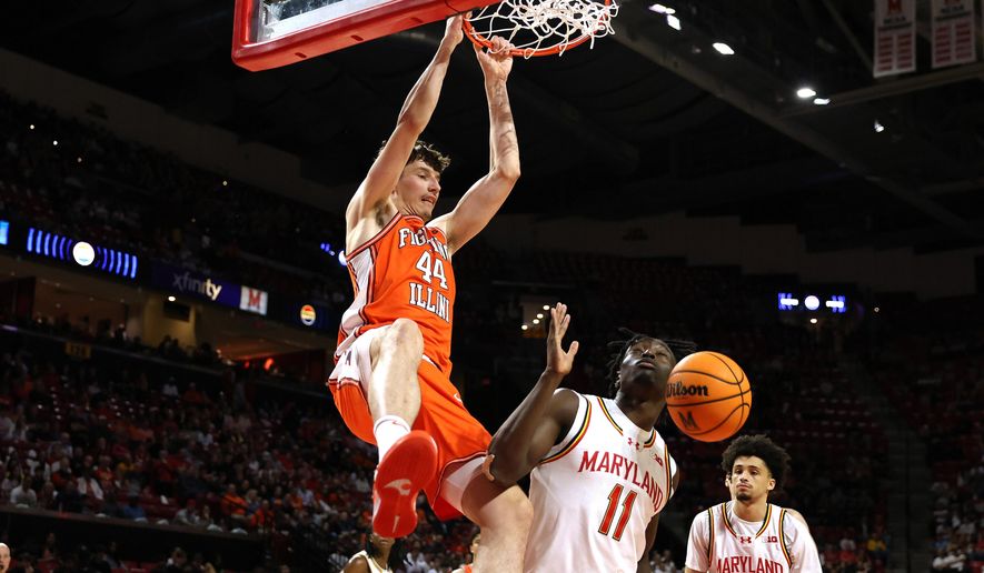 Illinois center Zvonimir Ivisic (44) dunks over Maryland guard George Turkson Jr. (11) during the first half of an NCAA college basketball game, Sunday, March 8, 2026, in College Park, Md. (AP Photo/Daniel Kucin Jr.)