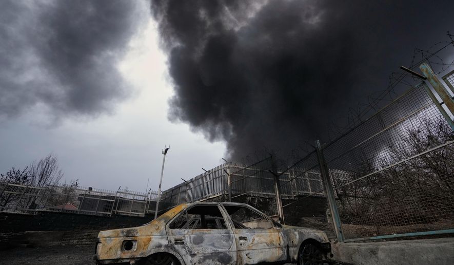 A thick plume of smoke rises from an oil storage facility hit by a U.S.-Israeli strike late Saturday in Tehran, Iran, Sunday, March 8, 2026. (AP Photo/Vahid Salemi)