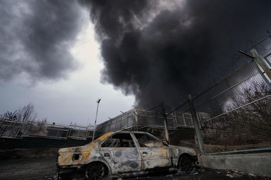 A thick plume of smoke rises from an oil storage facility hit by a U.S.-Israeli strike late Saturday in Tehran, Iran, Sunday, March 8, 2026. (AP Photo/Vahid Salemi)