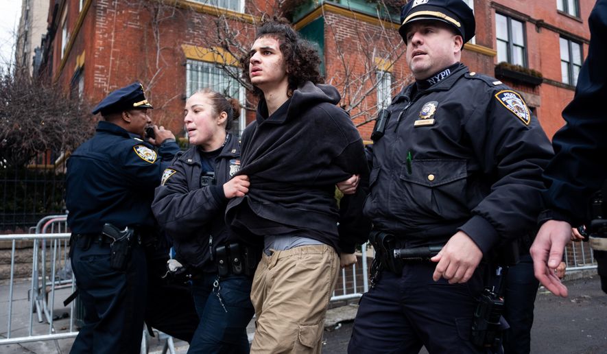 Police detain Emir Balat after he attempted to detonate an improvised explosive device during a counterprotest against far right influencer Jake Lang staging an anti-Islam protest outside Gracie Mansion, Saturday, March 7, 2026, in New York. (AP Photo/Julius Constantine Motal)