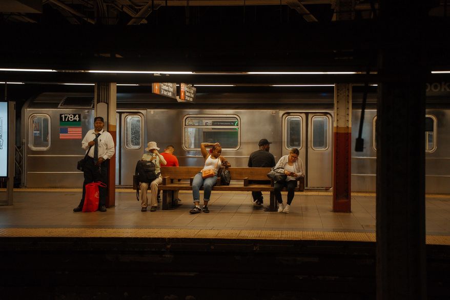 FILE - Passengers wait for the train on a subway platform during a heat wave on June 24, 2025, in New York. (AP Photo/Olga Fedorova, File)