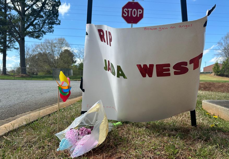 A paper sign left in memory of Jada West stands in her neighborhood in Villa Rica, Ga., Wednesday, March 11, 2026. (AP Photo/Kate Brumback)