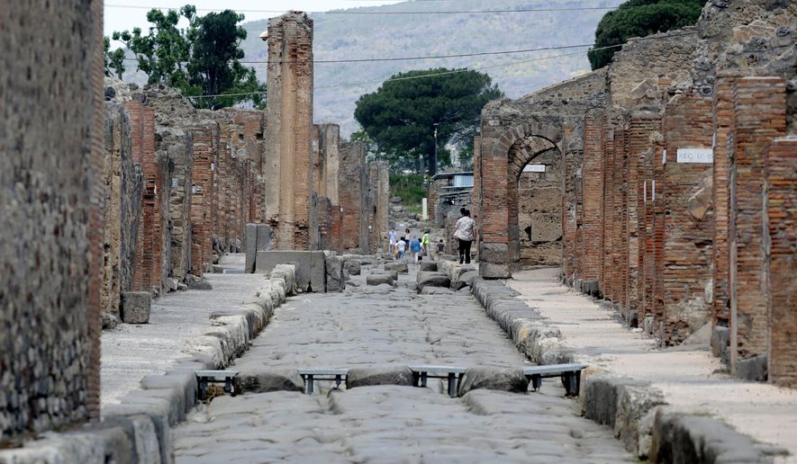 FILE -People visit the archaeological site of Pompeii, near Naples, southern Italy,Tuesday, May 26, 2020. (AP Photo/Alessandra Tarantino, File)