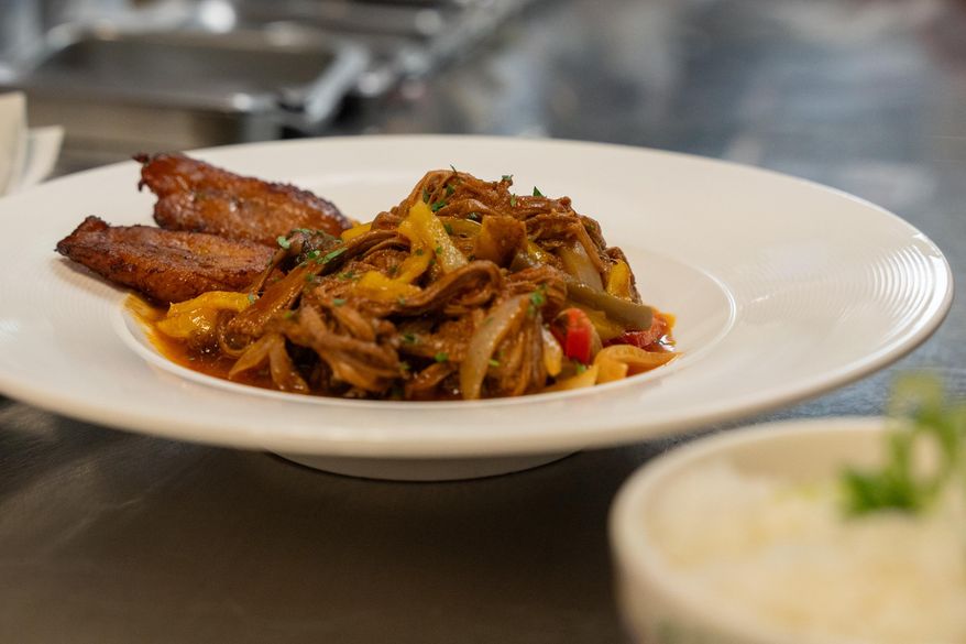 A ropa vieja dish from Cuba Libre Restaurant and Rum Bar's standard menu is prepared for serving at Cuba Libre Restaurant and Rum Bar in Philadelphia, on Friday, March 6, 2026. (AP Photo/Mingson Lau)