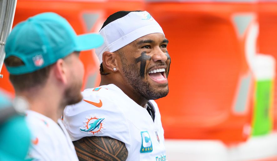 FILE - Miami Dolphins quarterback Tua Tagovailoa smiles on the bench during an NFL football game against the New Orleans Saints, Nov. 30, 2025, in Miami Gardens, Fla. (AP Photo/Doug Murray, File)