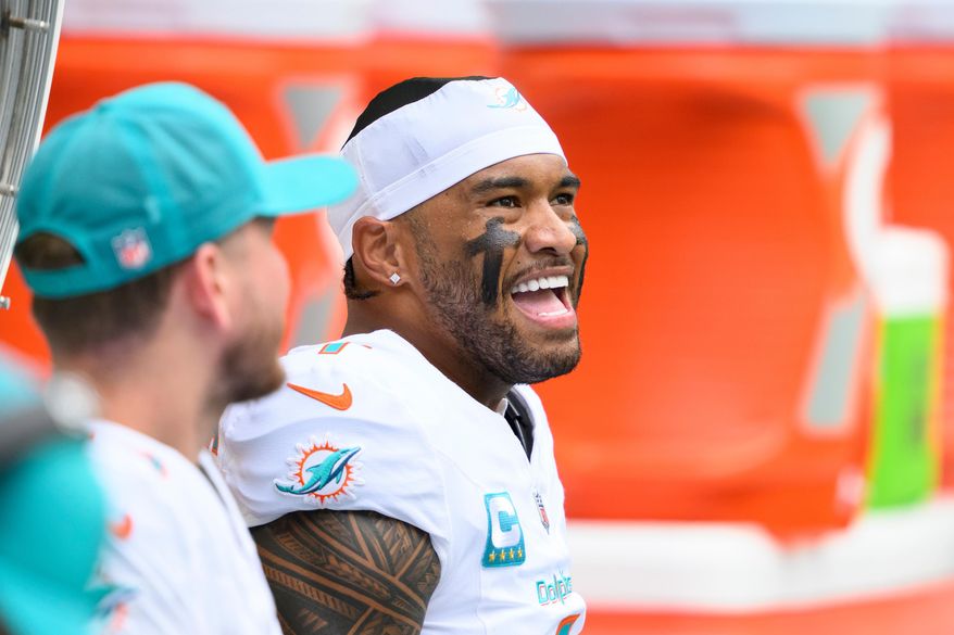 FILE - Miami Dolphins quarterback Tua Tagovailoa smiles on the bench during an NFL football game against the New Orleans Saints, Nov. 30, 2025, in Miami Gardens, Fla. (AP Photo/Doug Murray, File)
