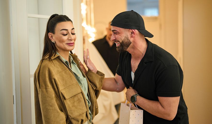 Gay Muslim influencer Ali Darwich, right, welcomes friends for an inclusive Iftar, the Ramadan fast-breaking meal, with friends who are Muslim, Christian, queer and straight, in Berlin, Germany, Wednesday, March 11, 2026. (AP Photo/Ebrahim Noroozi)