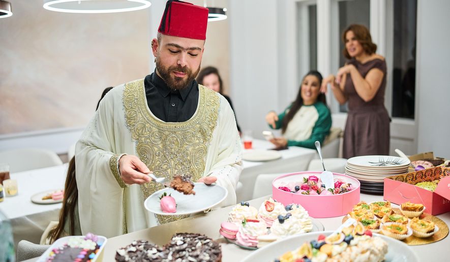 Haidar Darwish, a belly dancer and artist who came from Syria, attends an inclusive Iftar, the Ramadan fast-breaking meal, with friends who are Muslim, Christian, queer and straight, in Berlin, Germany, Wednesday, March 11, 2026. (AP Photo/Ebrahim Noroozi)