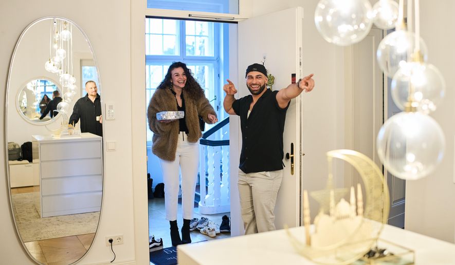 Gay Muslim influencer Ali Darwich, right, welcomes friends for an inclusive Iftar, the Ramadan fast-breaking meal, with friends who are Muslim, Christian, queer and straight, in Berlin, Germany, Wednesday, March 11, 2026. (AP Photo/Ebrahim Noroozi)