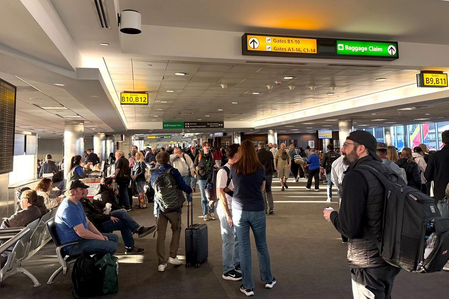 Stranded travelers crowd the Southwest domestic terminal at Baltimore-Washington International Thurgood Marshall Airport on Friday, March 13, 2026, after a ground stop. (Ellie Wolf/The Baltimore Banner via AP)