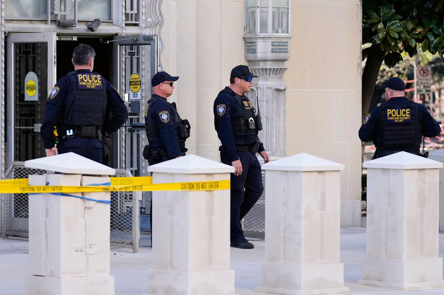 Officers with the Department of Homeland Security stand outside the Eldon B. Mahon U.S. Courthouse during a trial for nine people connected to a 2025 shooting outside an ICE detention facility, in Fort Worth, Texas, Thursday, March 12, 2026. (AP Photo/Tony Gutierrez)
