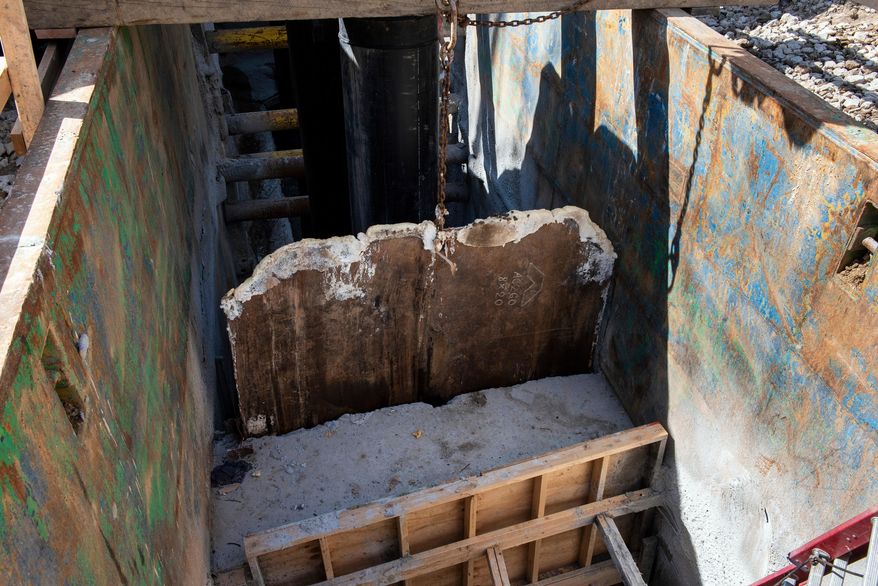 A gate is raised, allowing raw sewage to flow to an interceptor pipe along the C&O Canal, beside the Potomac River, in Cabin John, Md., Saturday, March 14, 2026. (AP Photo/Cliff Owen)