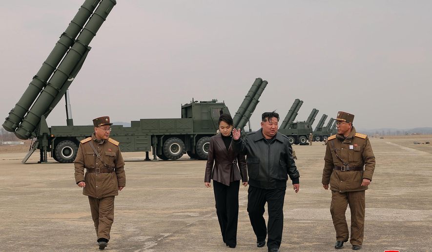 In this photo provided by the North Korean government, its leader Kim Jong-un, center right, and his daughter, center left, attend a live-fire test of multiple rocket launch systems, at an undisclosed place in North Korea Saturday, March 14, 2026. Independent journalists were not given access to cover the event depicted in this image distributed by the North Korean government. The content of this image is as provided and cannot be independently verified. Korean language watermark on image as provided by source reads: "KCNA" which is the abbreviation for Korean Central News Agency. (Korean Central News Agency/Korea News Service via AP)