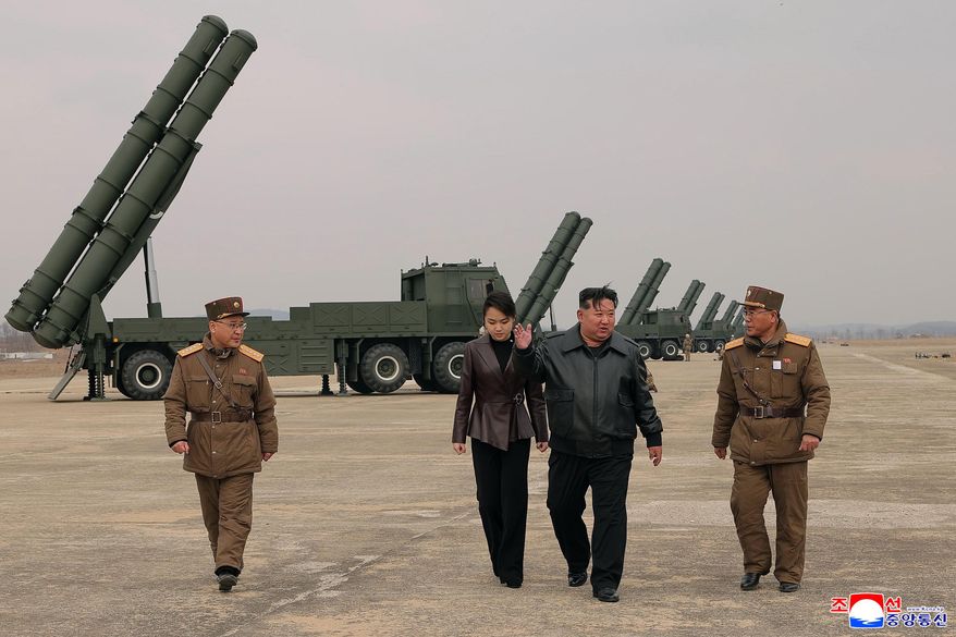 In this photo provided by the North Korean government, its leader Kim Jong-un, center right, and his daughter, center left, attend a live-fire test of multiple rocket launch systems, at an undisclosed place in North Korea Saturday, March 14, 2026. Independent journalists were not given access to cover the event depicted in this image distributed by the North Korean government. The content of this image is as provided and cannot be independently verified. Korean language watermark on image as provided by source reads: "KCNA" which is the abbreviation for Korean Central News Agency. (Korean Central News Agency/Korea News Service via AP)