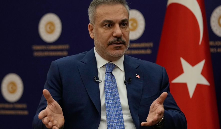 Turkey's Foreign Minister Hakan Fidan speaks during an interview with The Associated Press, in Ankara, Turkey, Saturday, March 14, 2026. (AP Photo/Khalil Hamra)