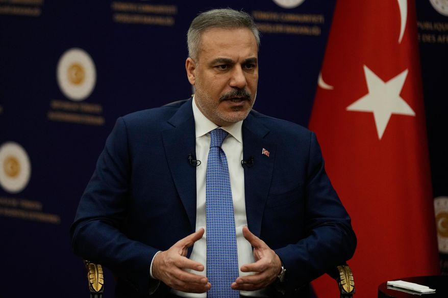 Turkey's Foreign Minister Hakan Fidan speaks during an interview with The Associated Press, in Ankara, Turkey, Saturday, March 14, 2026. (AP Photo/Khalil Hamra)