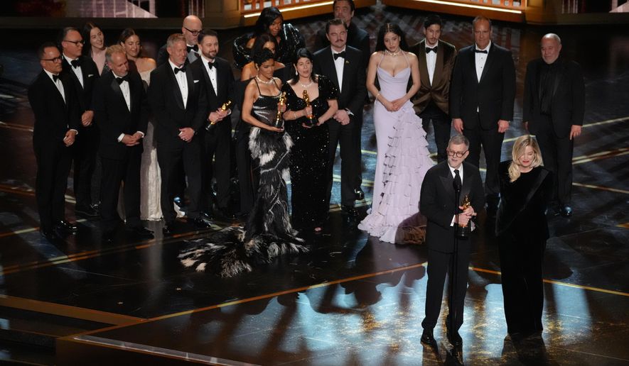 Paul Thomas Anderson, left center, Sara Murphy, right center, and the team from "One Battle After Another" accept the award for best picture during the Oscars on Sunday, March 15, 2026, at the Dolby Theatre in Los Angeles. (AP Photo/Chris Pizzello)