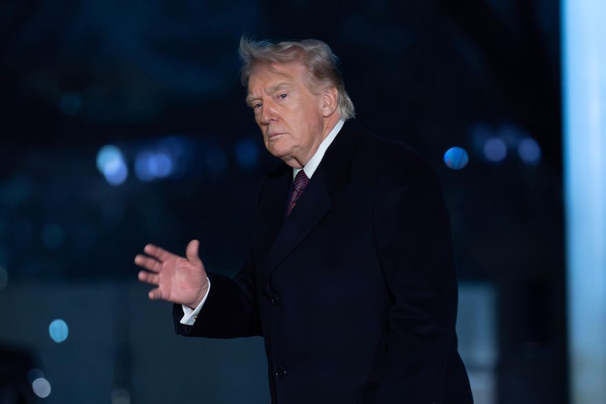 President Donald Trump gesture to the media as he walks on the South Lawn upon his arrival to the White House, Sunday, March 15, 2026, in Washington. (AP Photo/Jose Luis Magana)